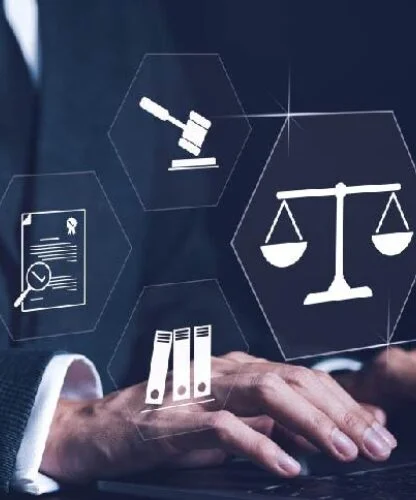 Person in a suit typing on a laptop with holographic legal icons (scales of justice, gavel, courthouse) floating around.