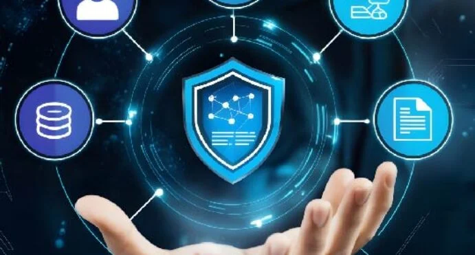 Hand supporting a glowing shield with a network diagram, surrounded by circular security icons (user, database, documents, chat) indicating cybersecurity protection.