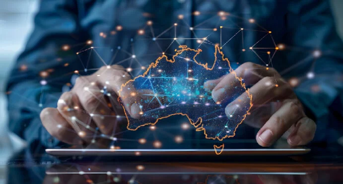 Hands tapping a tablet with a glowing holographic map of Australia and connected network nodes, symbolizing data connectivity in Australia.