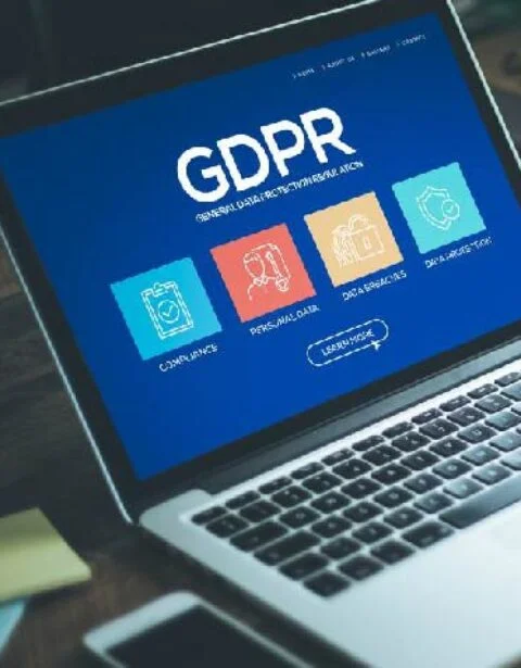 Laptop screen displaying a GDPR dashboard with five color-coded icons for compliance topics.