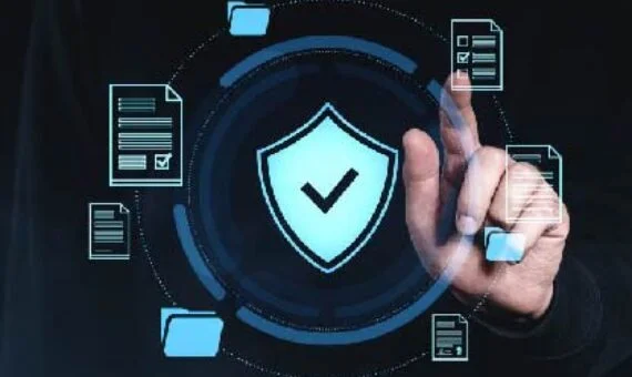 Person taps a glowing shield with a checkmark, surrounded by floating document and folder icons, symbolizing data security.
