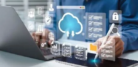 Person using a laptop with glowing cloud computing icons and data security symbols hovering above the screen area.