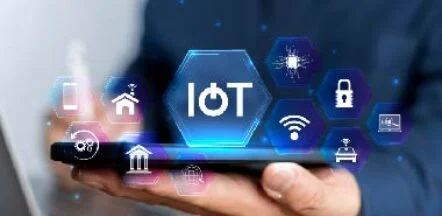 IoT concept with hex icons hovering above a hand holding a tablet, symbolizing connected devices and smart tech.